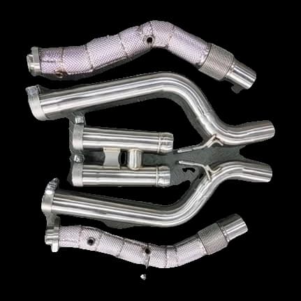 M157 downpipes with heat wrap and flex sections, front pipes and H-pipe section for the S 63, laid out on a steel floor